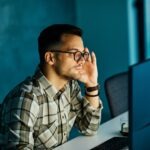 businessman working late night business computer man office technology light dark young internet