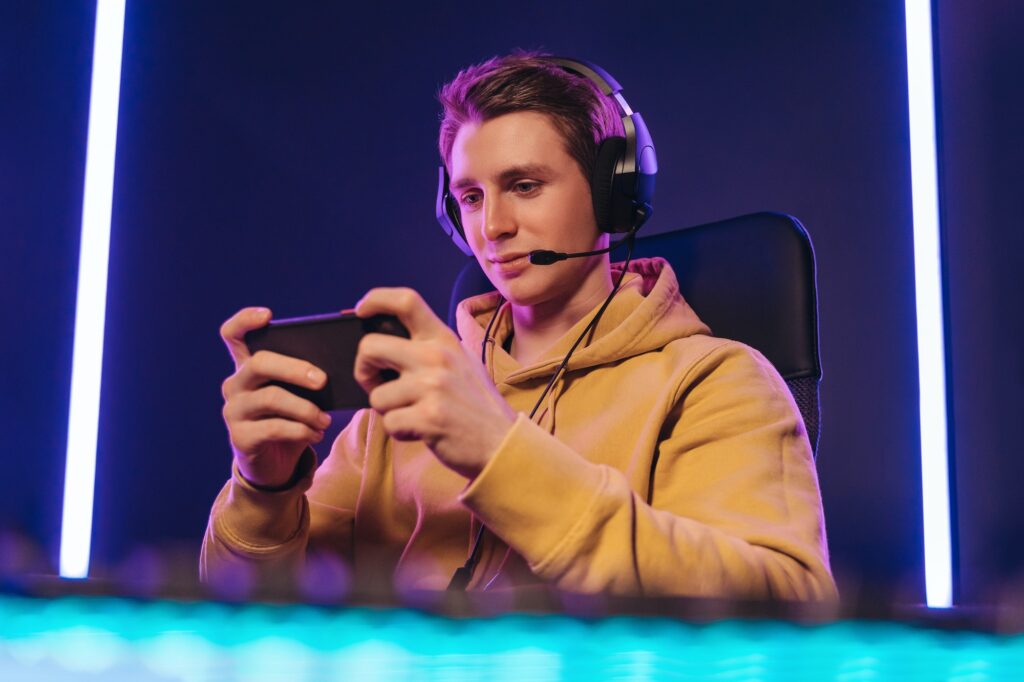 pro cyber sportsman playing in mobile video game at home