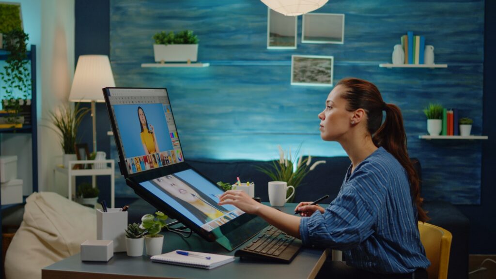 retouch specialist using image editing software at photography studio