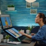 retouch specialist using image editing software at photography studio